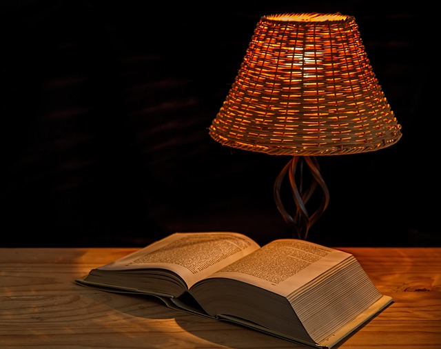 large book, open, by lamp
